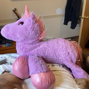 Two large stuffed animals, dog and unicorn